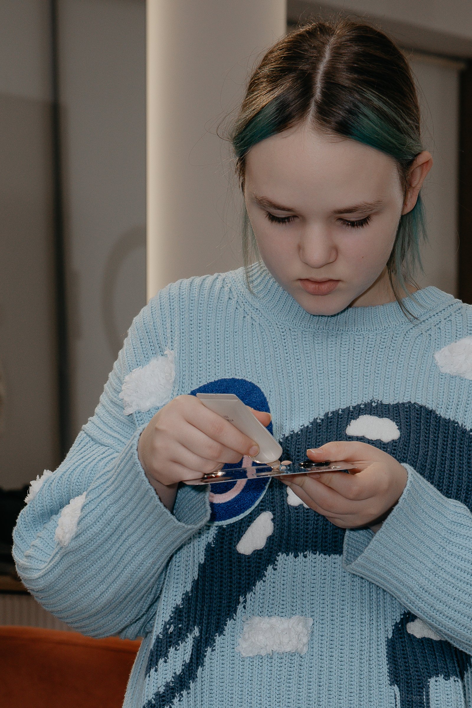 A teen choosing color from a small makeup palette