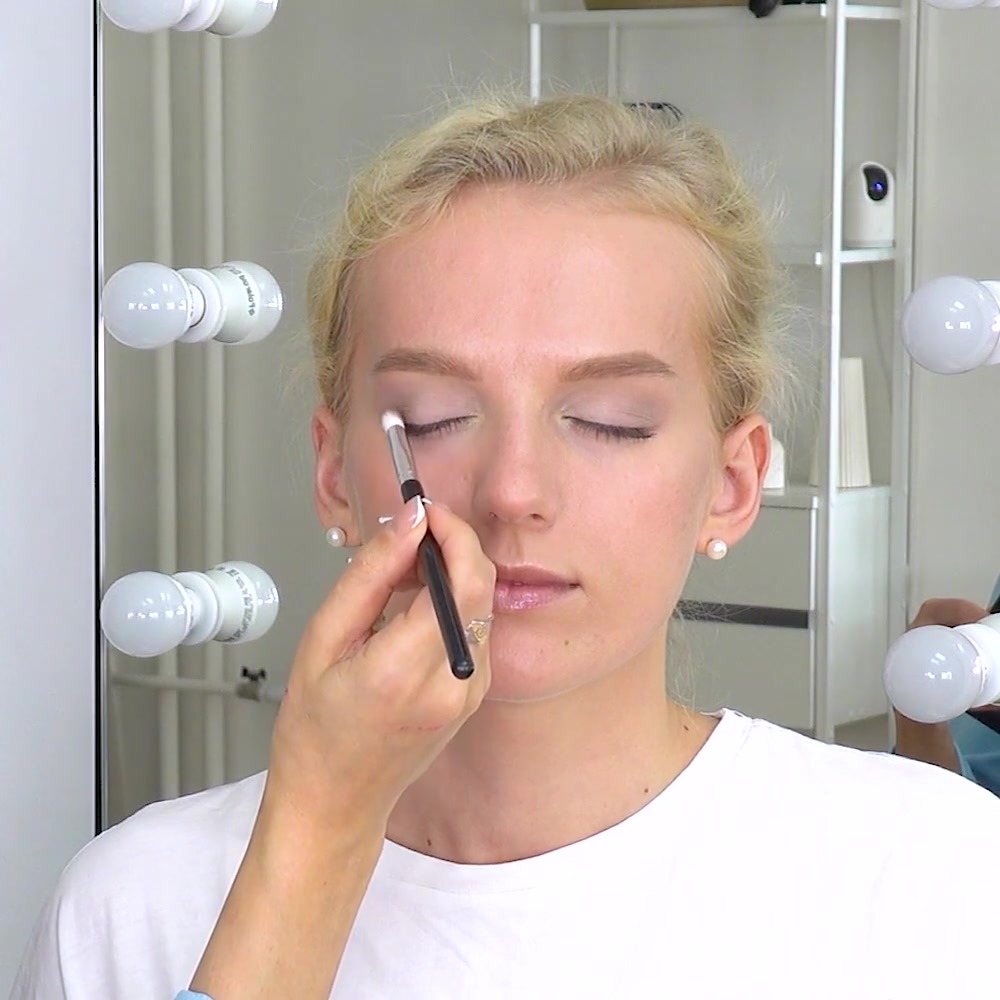 A deeper neutral shade is placed at the outer corner of the eye