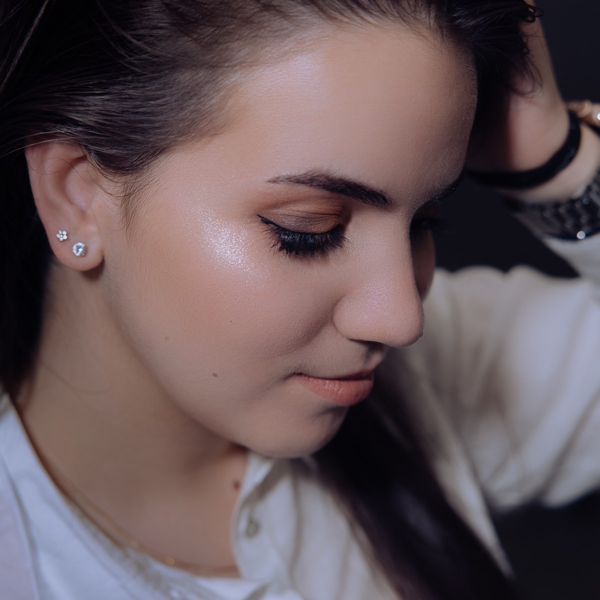 Close-up of a bronze eye makeup look with black liner and highlighted cheeks