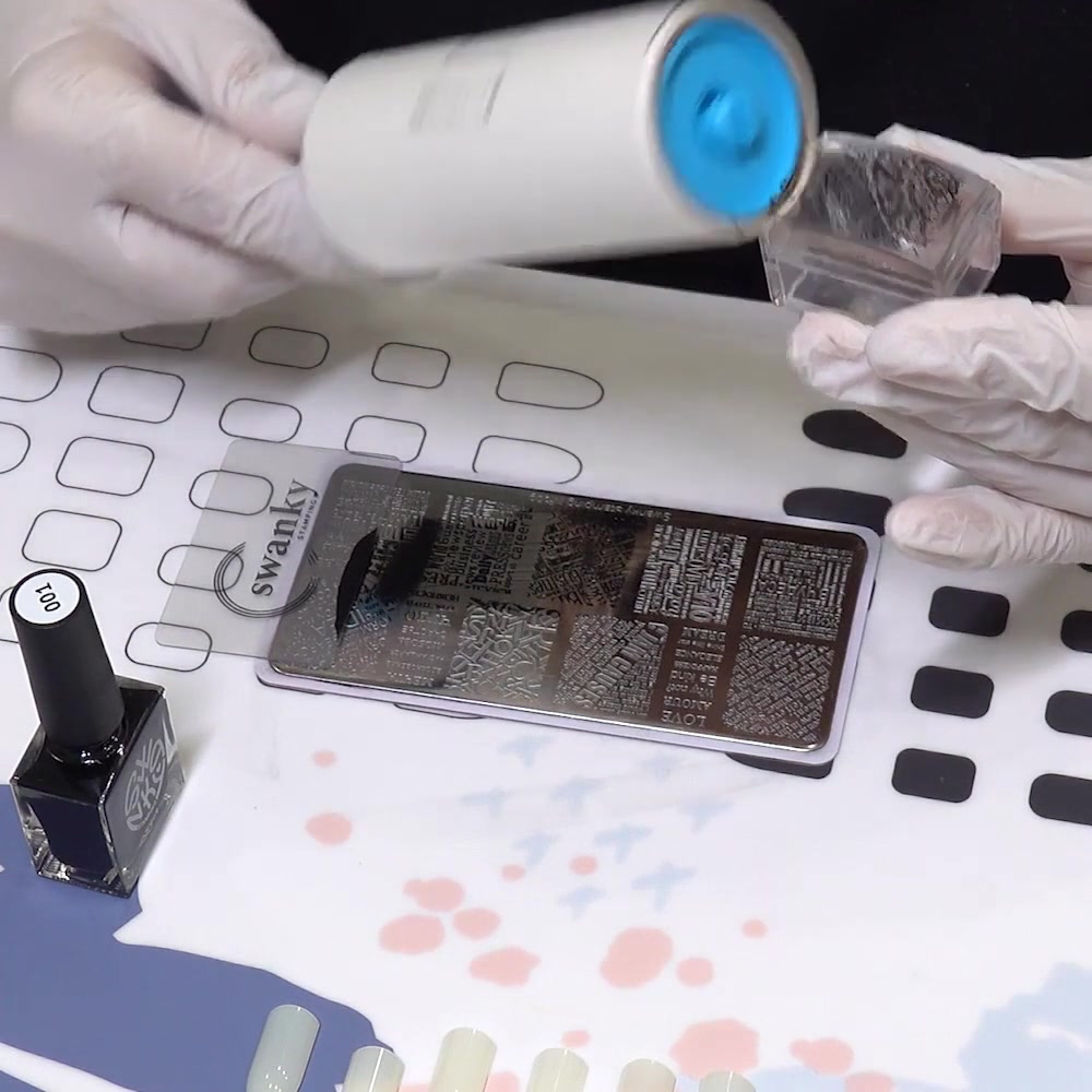 A piece of tape removes unwanted polish from the clear stamper head