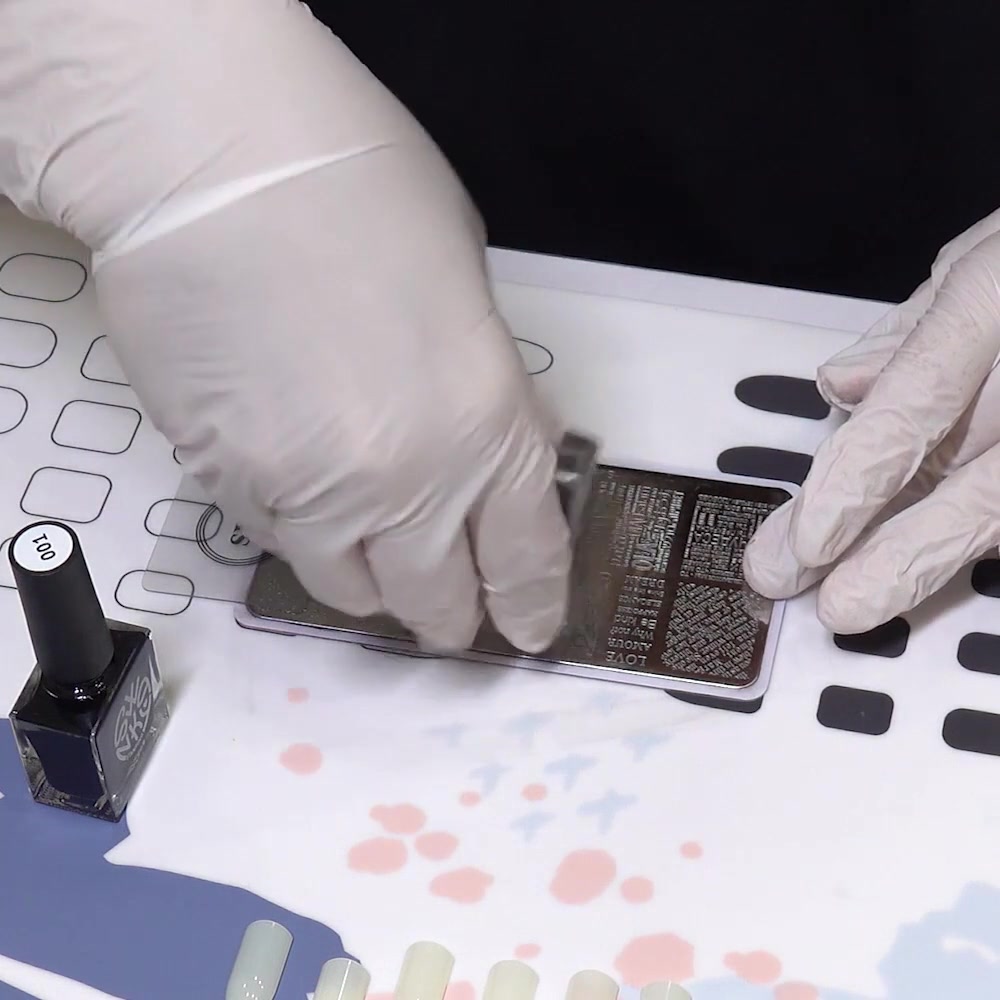A clear silicone stamper rolls lightly across the engraved design