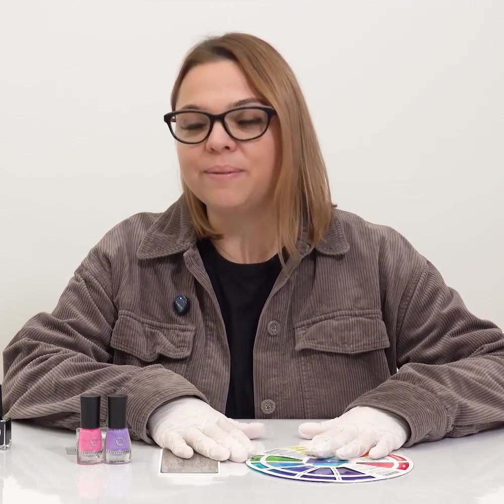 The instructor shows an engraved metal nail stamping plate