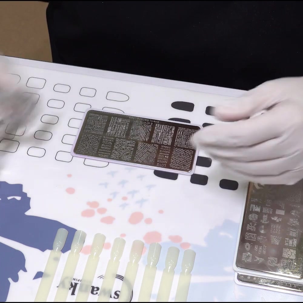 A stamping plate, scraper, clear stamper, polish, and lint roller are arranged for practice
